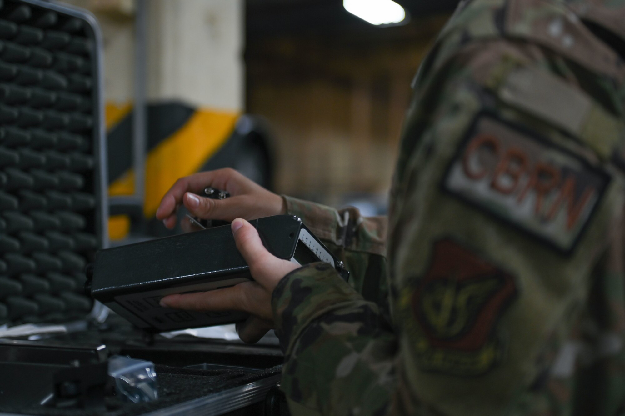 Airman inspects a radiation device