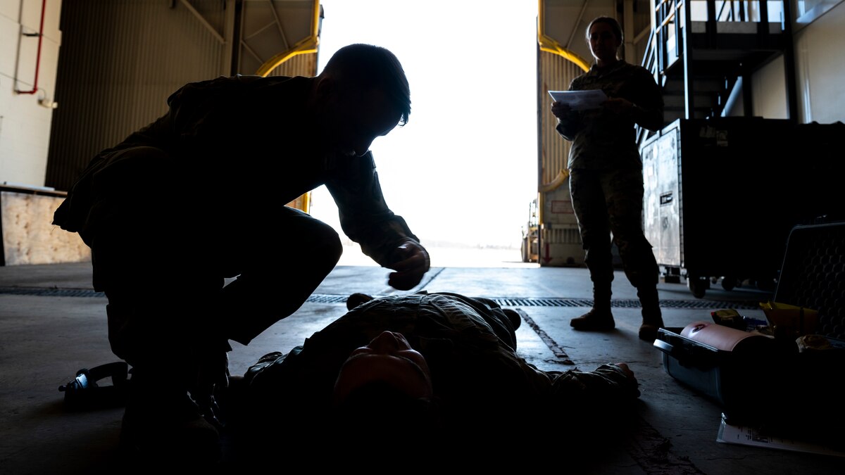 Airmen performing life-saving techniques during a class
