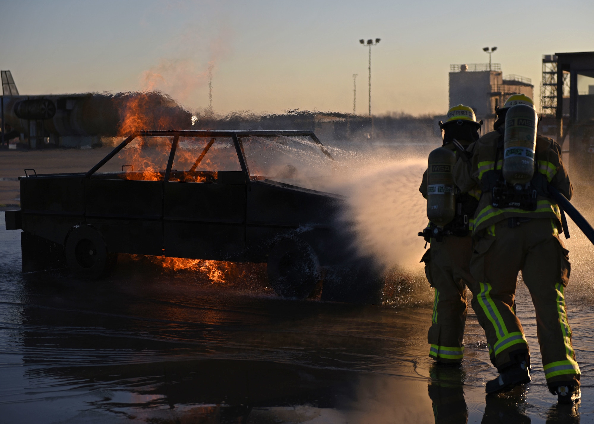 Students assigned to the 312th Training Squadron douse a vehicle fire at the Louis F. Garland Department of Defense Fire Academy, Goodfellow Air Force Base, March 9, 2022. The vehicle fire trainer is a part of the Fire Suppression block, which is taught for 20 academic days. (U.S. Air Force photo by Airman 1st Class Sarah Williams)