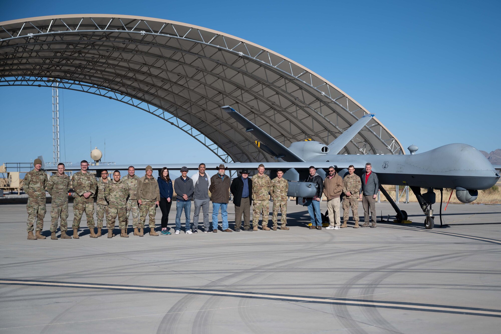 Airmen assigned to the 214 LRE at U.S. Army Ft. Huachuca, Arizona, AATC in Tucson, Arizona, and several contractors and support personnel pose with an MQ-9 Reaper with the REAP 2.0 payload prior to an operational assessment flight on March 11.