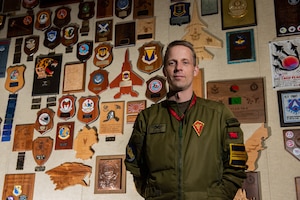 Maj. Daniel Jannerstad, Swedish Air Force air boss, stands in a heritage room during Red Flag-Nellis 22-2 at Nellis Air Force Base, Nev., March 15, 2022. The Swedish Air Force participation promotes interoperability between friendly forces and the exchange of information for both future Red Flag exercises and the Swedish Arctic Challenge Exercise. (U.S. Air Force photo by Airman 1st Class Josey Blades)