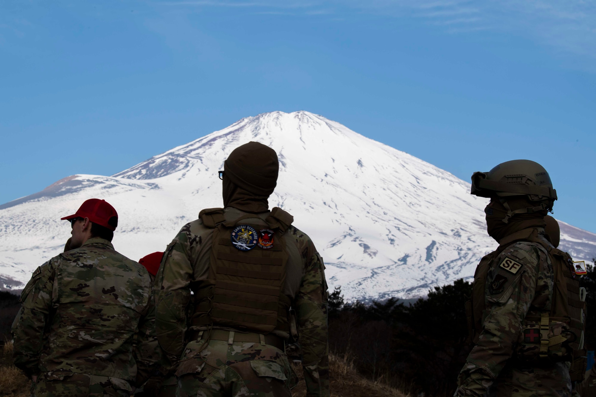 Defenders from the 374th Security Forces Squadron wait for a weapons briefing prior to an M240 and M249 machine guns qualification at Combined Arms Training Center Camp Fuji, Japan, March 10, 2022.