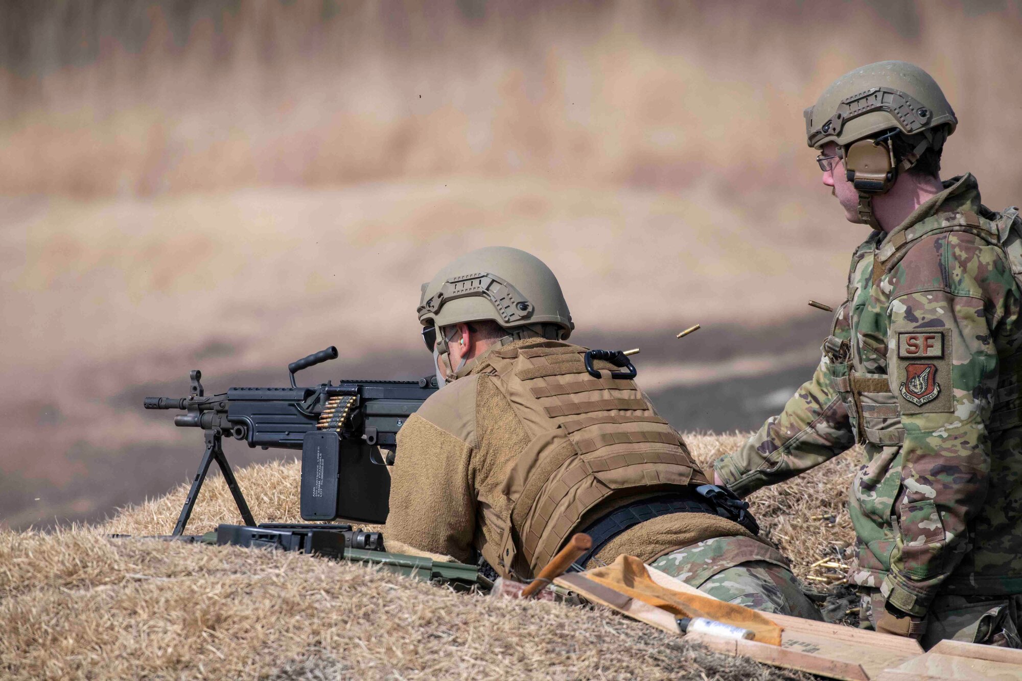 Airmen from the 374th Security Forces Squadron fire an M249 during a machine guns qualification at Combined Arms Training Center Camp Fuji, Japan, March 10, 2022.