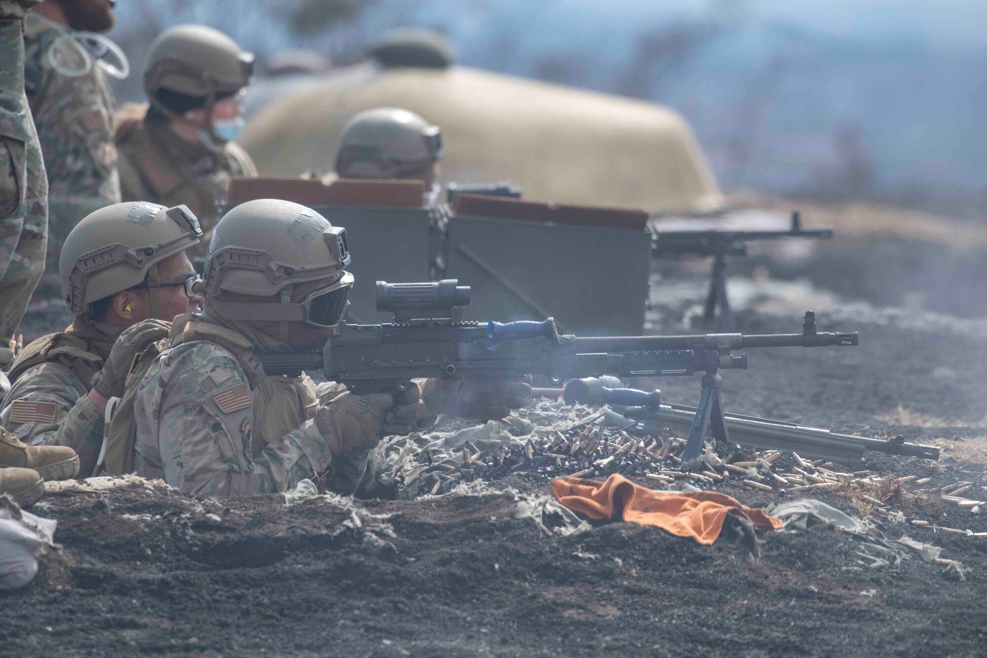 Defenders with the 374th Security Forces Squadron fire their M240 and M249 machine guns in two person teams at Combined Arms Training Center Camp Fuji, Japan, March 10, 2022.
