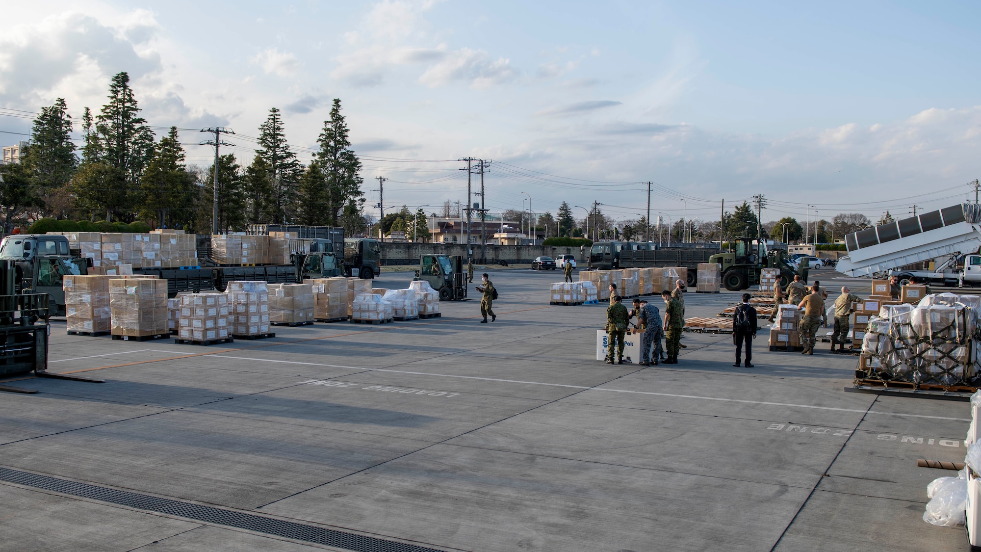 A outside cargo loading area is covered with piles of boxes.