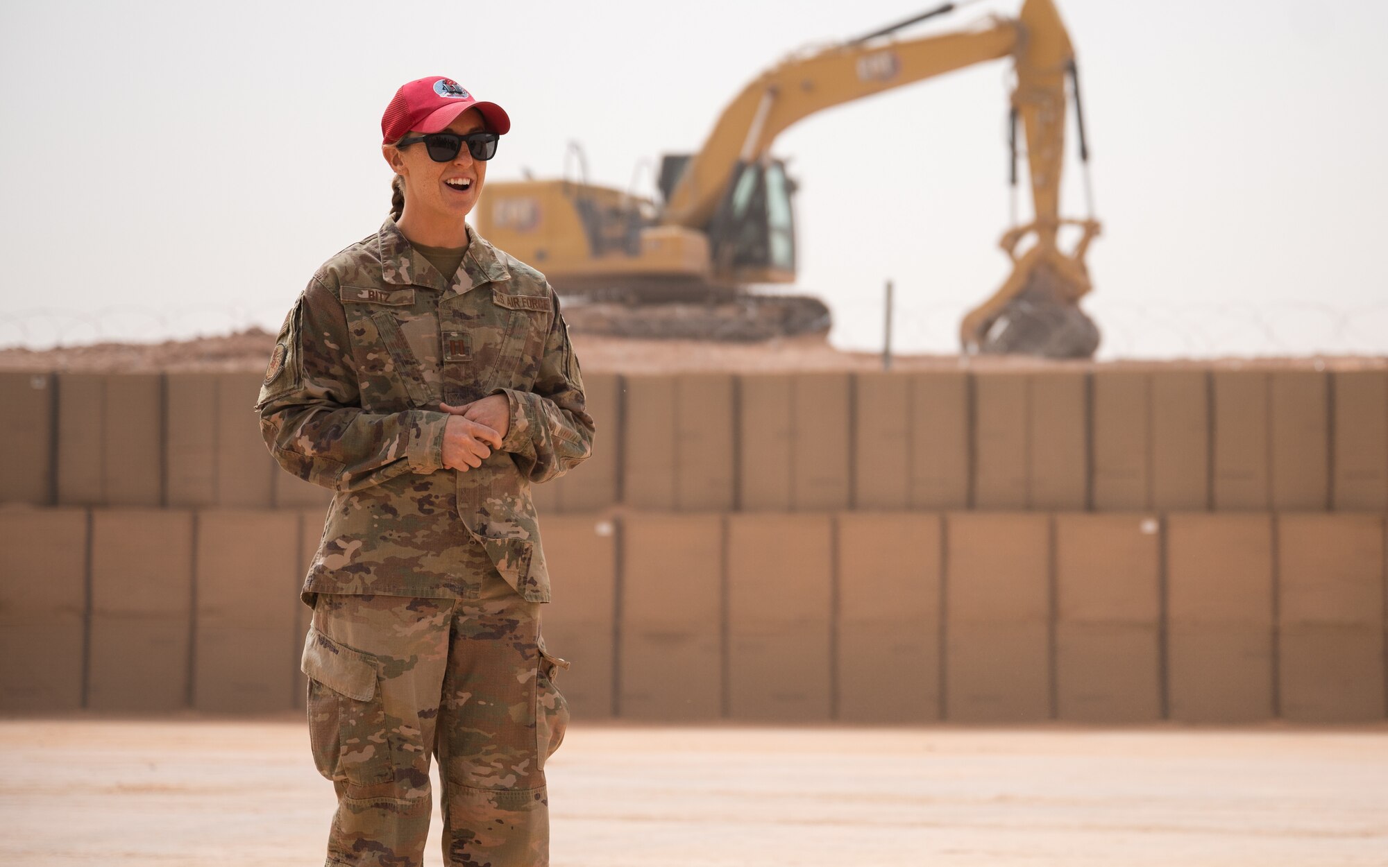 Capt. Ericka Bitz, 557th Expeditionary Red Horse Squadron officer-in-charge, addresses the crowd at a munitions storage area expansion ribbon cutting ceremony at Prince Sultan Air Base, Kingdom of Saudi Arabia, March 16, 2022. The expansion of the munitions storage area greatly increases the lethality of the U.S. Air Forces in the region by progressing the fortification of the base’s facilities and allowing more weapons to be safely stored at PSAB (U.S. Air Force photo by Senior Airman Jacob B. Wrightsman)
