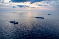 From left to right, the French aircraft carrier Charles de Gaulle (R 91), the Nimitz-class aircraft carrier USS Harry S. Truman (CVN 75) and the Italian aircraft carrier ITS Cavour (C 550) transit the Ionian Sea in formation, Mar. 17, 2022.