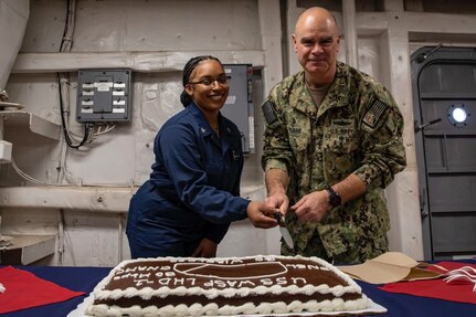 Information Systems Technician 3rd Class Jamira Jenkins joined Rear Adm. Brendan McLane, Commander, Naval Surface Force Atlantic, to celebrate the successful first-of-its-kind launch of a shipyard-based Wireless Connectivity Bridge while the ship is in BAE Systems Norfolk Ship Repair shipyard.