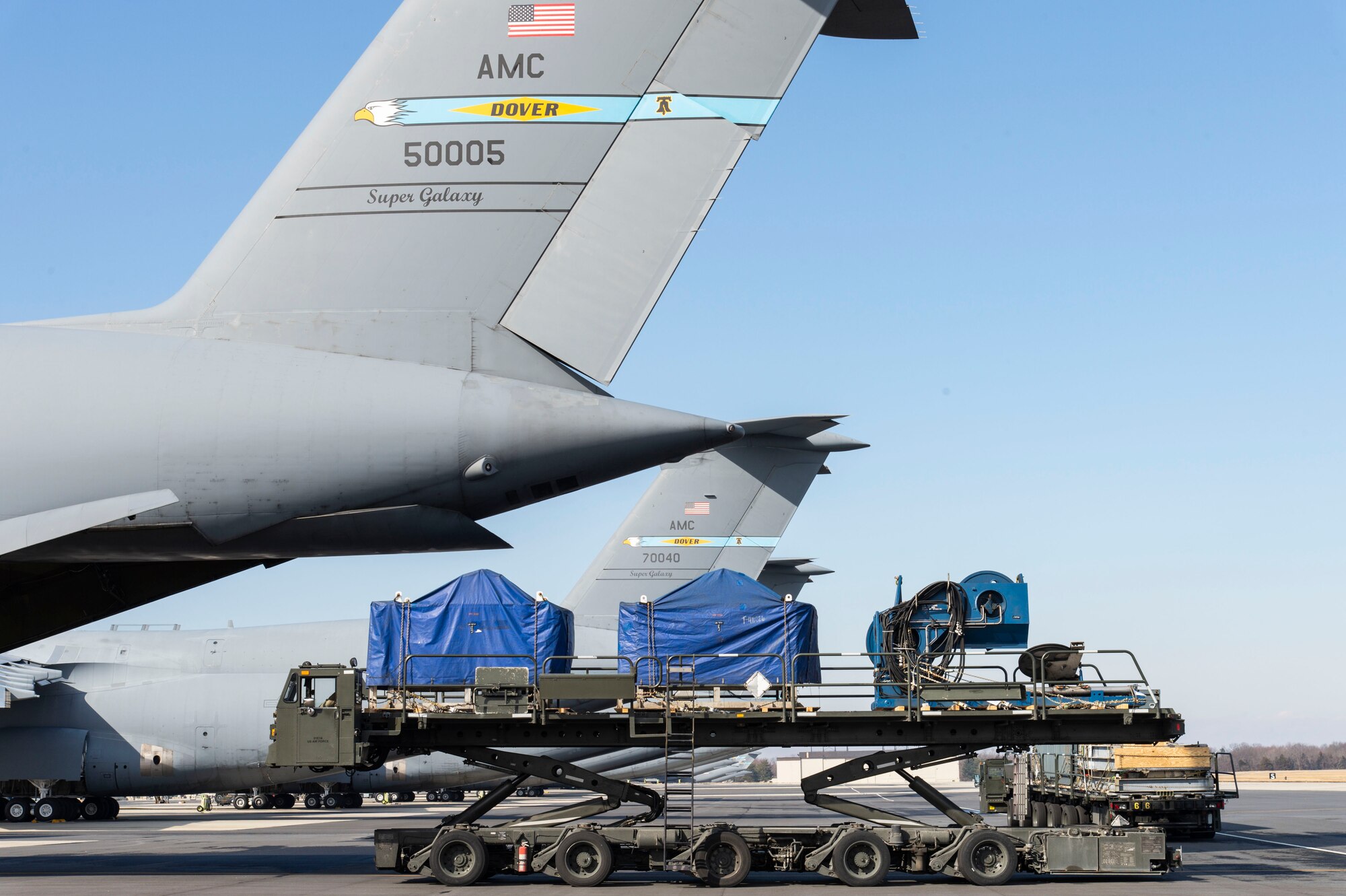 Staff Sgt. Brett Dehner, 436th Aerial Port Squadron ramp services supervisor, positions a cargo loader at the rear of a C-5M Super Galaxy at Dover Air Force Base, Delaware, Feb. 8, 2022. The C-5M transported cargo owned by U.S. Navy Supervisor of Salvage and Diving (SUPSALV), Naval Sea Systems Command. (U.S. Air Force photo by Roland Balik)