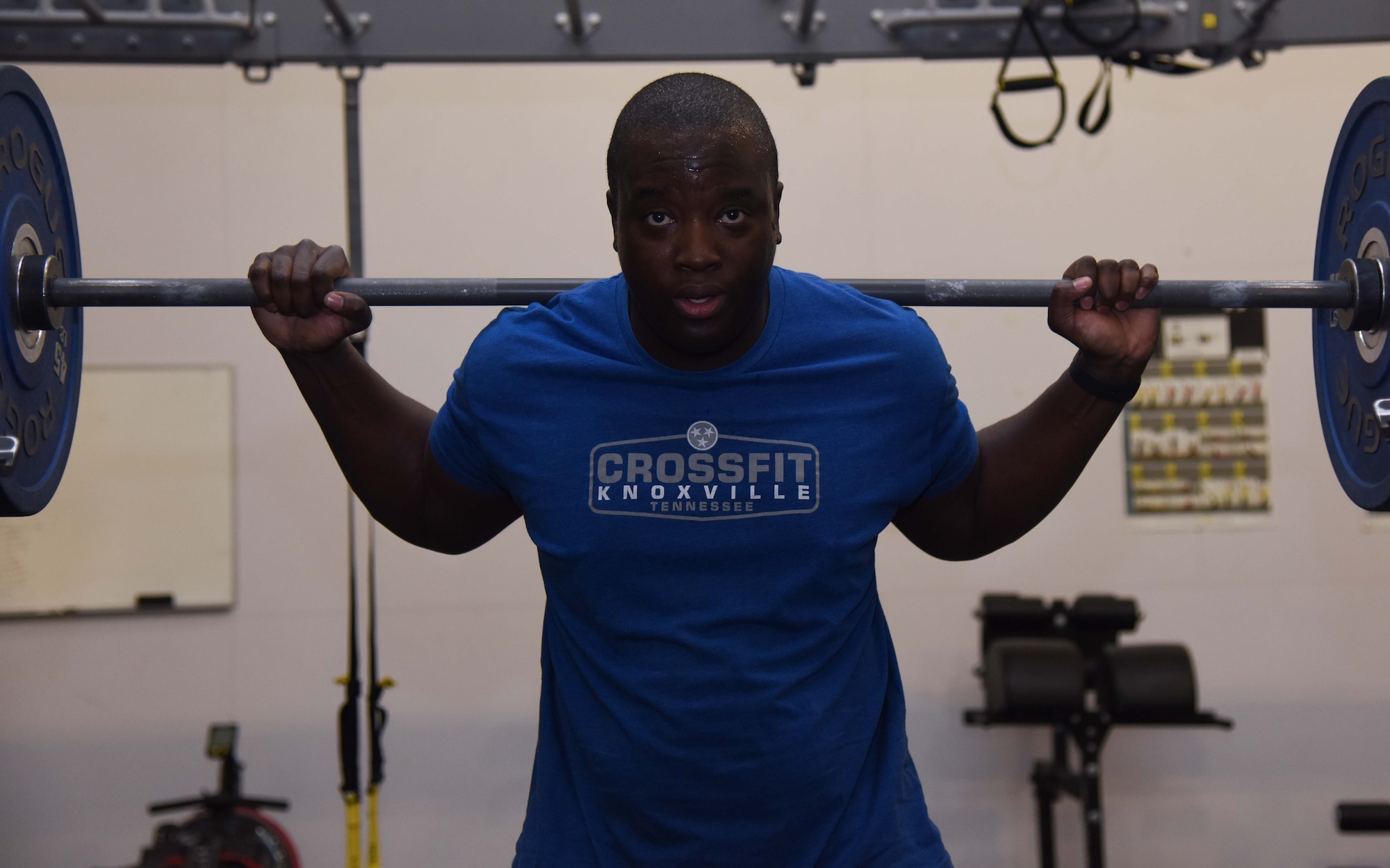 Man lifts weights in gym