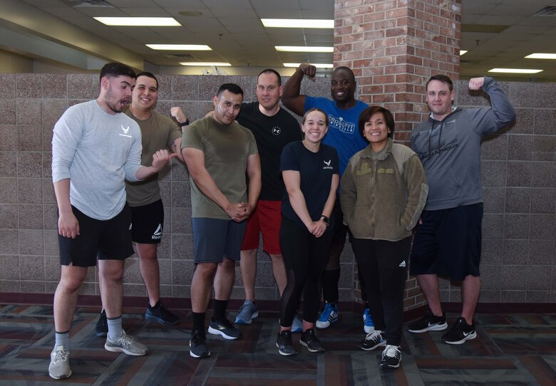 Group of people poses for a picture in gym