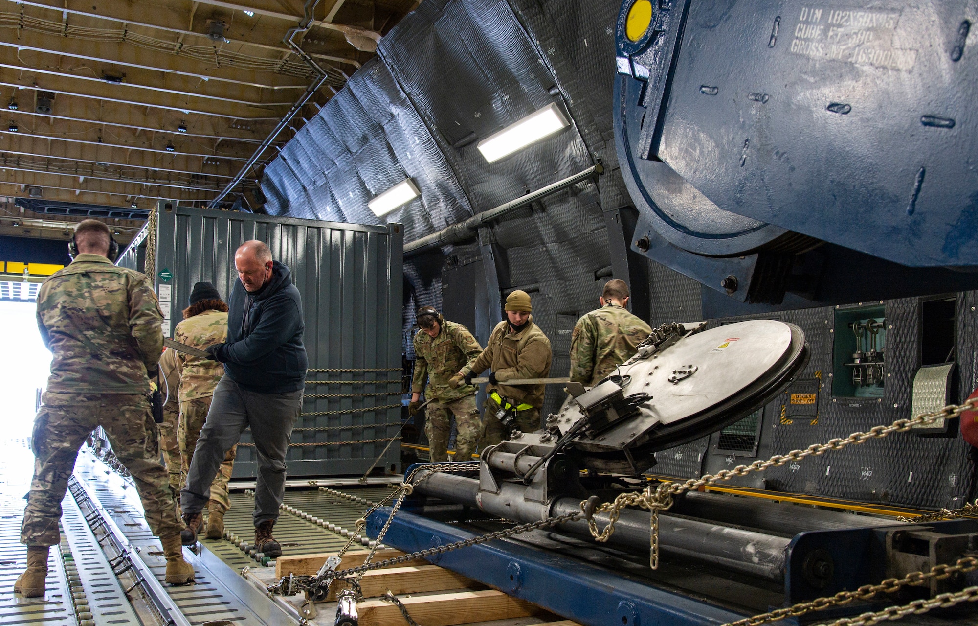 Loadmasters from the 9th Airlift Squadron along with 436th Aerial Port Squadron ramp services personnel, load cargo onto a C-5M Super Galaxy at Dover Air Force Base, Delaware, Feb. 8, 2022. The C-5M transported cargo owned by U.S. Navy Supervisor of Salvage and Diving (SUPSALV), Naval Sea Systems Command. (U.S. Air Force photo by Roland Balik)