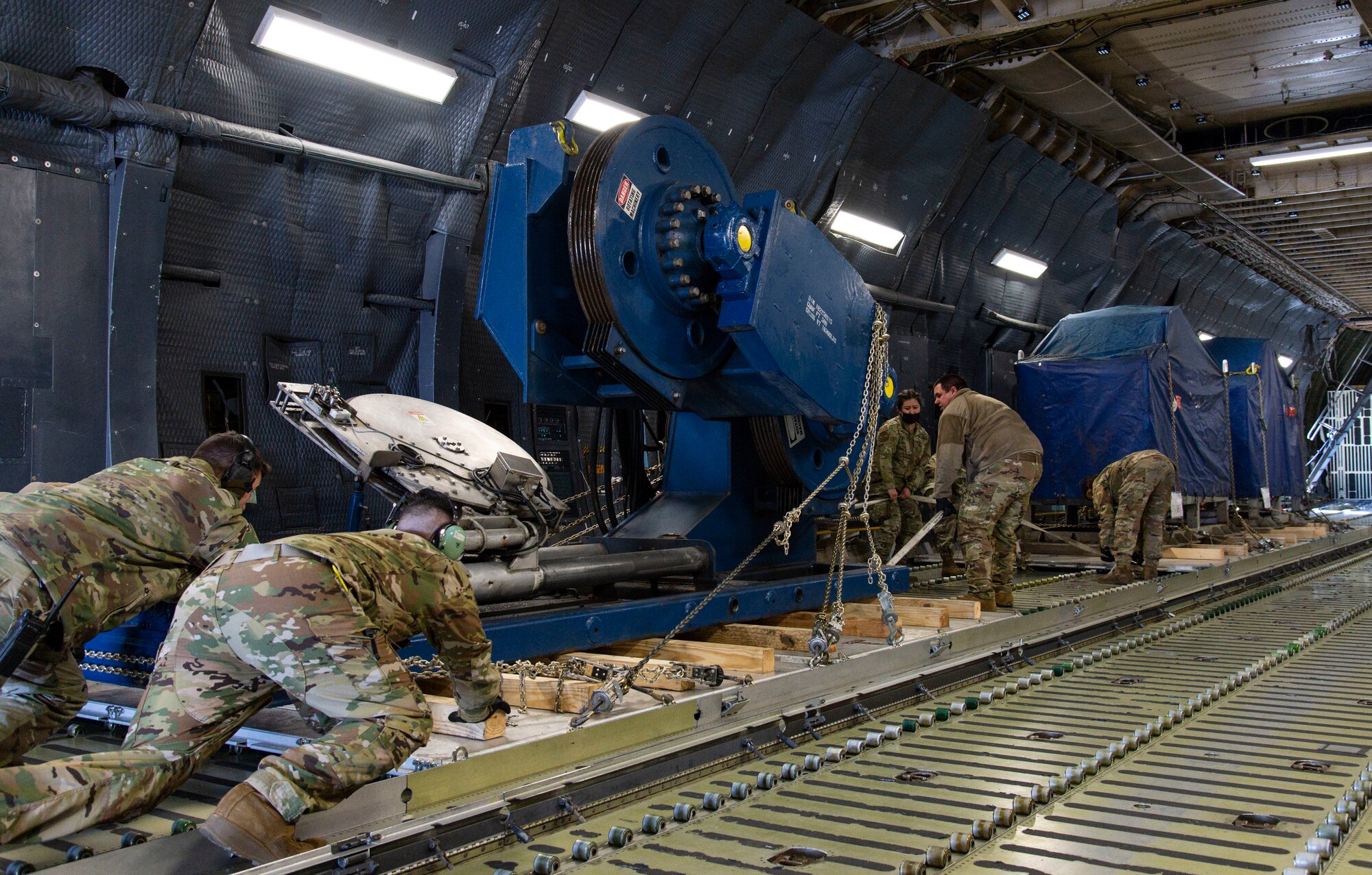 Loadmasters from the 9th Airlift Squadron along with 436th Aerial Port Squadron ramp services personnel, load cargo onto a C-5M Super Galaxy at Dover Air Force Base, Delaware, Feb. 8, 2022. The C-5M transported cargo owned by U.S. Navy Supervisor of Salvage and Diving (SUPSALV), Naval Sea Systems Command. (U.S. Air Force photo by Roland Balik)