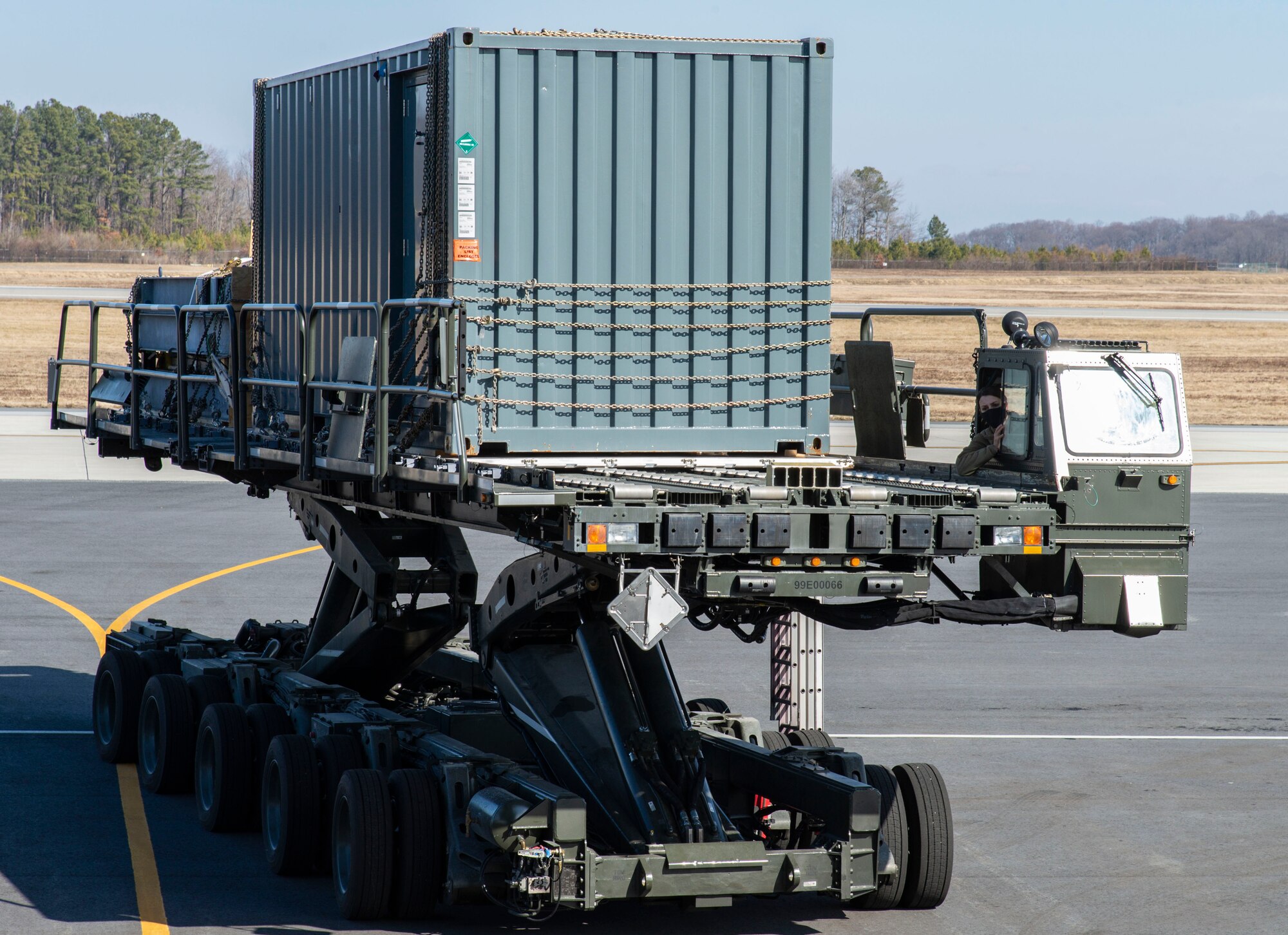 Senior Airman Kaitlyn Van Orden, 436th Aerial Port Squadron ramp specialist, drives a cargo loader towards the rear of a C-5M Super Galaxy at Dover Air Force Base, Delaware, Feb. 8, 2022. The C-5M transported cargo owned by U.S. Navy Supervisor of Salvage and Diving (SUPSALV), Naval Sea Systems Command. (U.S. Air Force photo by Roland Balik)