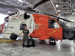 Lt. Cmdr. Meg Peters with a HH-60 Jayhawk helicopter, the aircraft that she specializes in flying.  Photo courtesy of U.S. Coast Guard Air Station Elizabeth City.