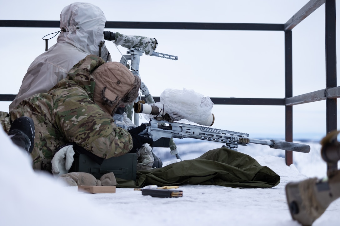 A Special Forces sniper team assigned to 10th Special Forces Group (Airborne) observe a target during pre-deployment training for ARCTIC EDGE 22 at Yukon Training Area, Alaska, Feb. 21, 2022. ARCTIC EDGE 22, February 28 – March 17, is a U.S. Northern Command (USNORTHCOM) exercise scheduled every two years, designed to provide realistic and effective training for participants using the premier training locations available throughout Alaska. (U.S. Army photo by Staff Sgt. Anthony Bryant)