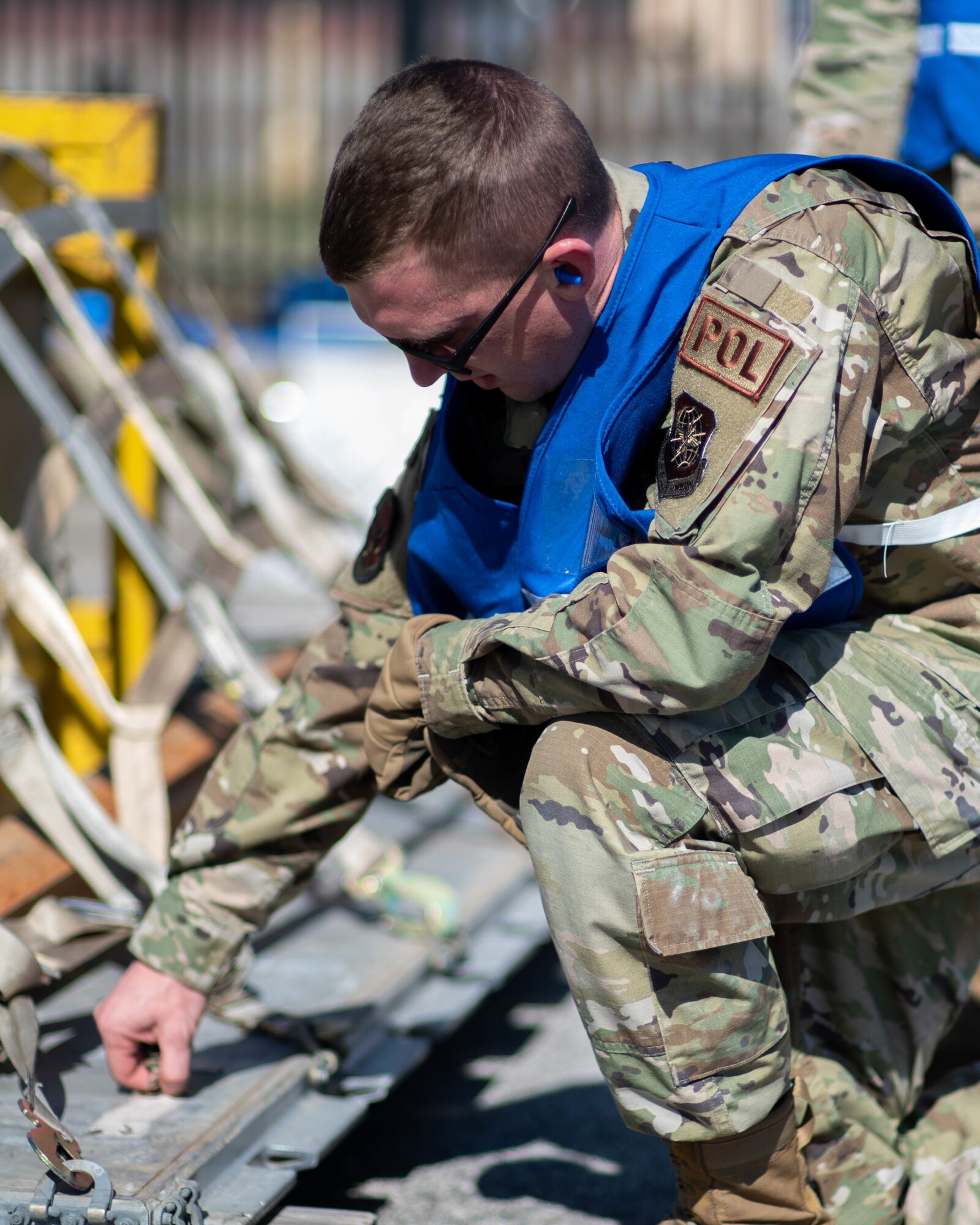 U.S. Air Force Airman 1st Class Phillip Walter, 375th Logistics Readiness Squadron fuels controller, inspects a pallet during a mobility deployment rehearsal, on Scott Air Force Base, Illinois, March 16, 2022. This deployment mobility rehearsal emphasizes readiness of command and control procedures and continuity of operations in a simulated contested environment. (U.S. Air Force photo by Airman 1st Class Violette Hosack)