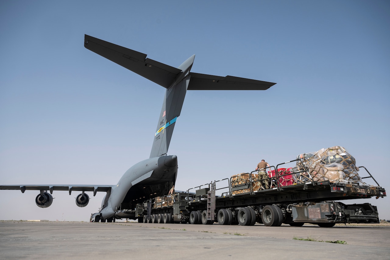 Troops offload an aircraft.