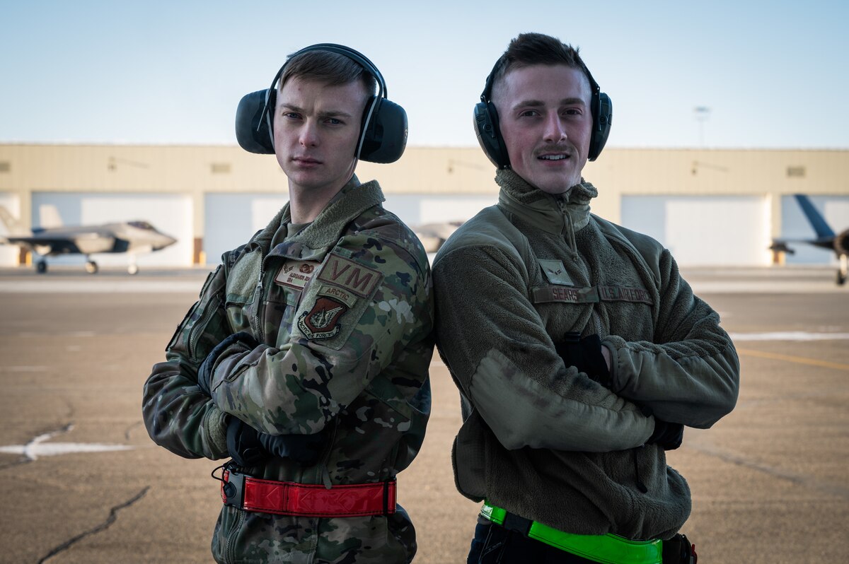 U.S. Air Force Senior Airman Aleksandr Zenski, a 354th Logistics Readiness Squadron vehicle maintenance journeyman (left), and Airman 1st Class Ian Spears, a 356th Aircraft Maintenance Unit crew chief, pose for a photo during a ‘Crew Chief for a Day’ immersion on Eielson Air Force Base, Alaska, March 15, 2022.