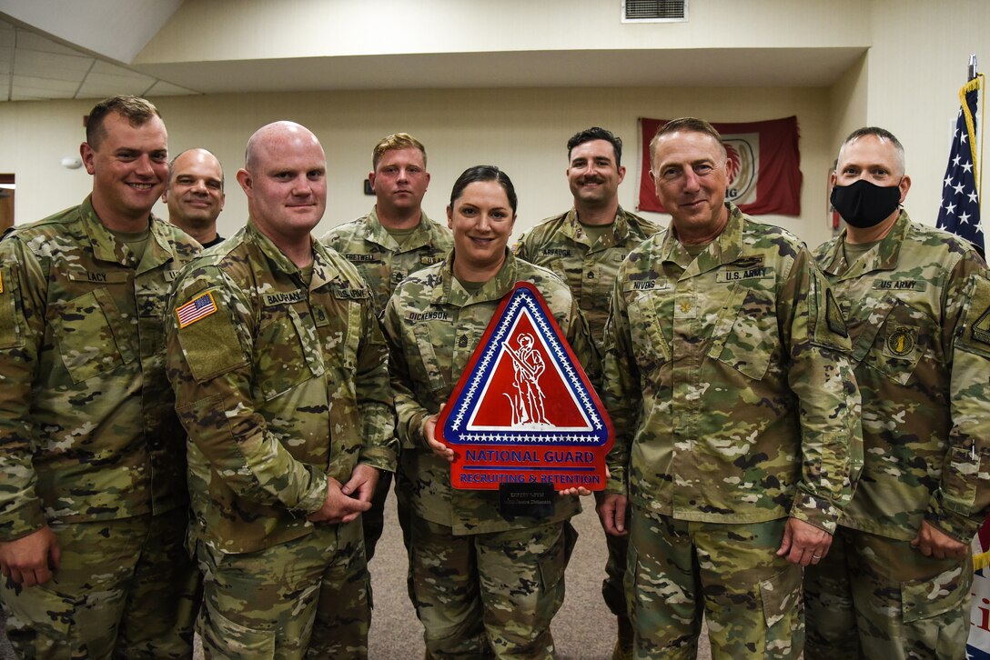 Master Sgt. Jessica Dickenson, center, poses with her team during an awards ceremony with the Virginia Army National Guard’s Recruiting and Retention Battalion June 11, 2021, at the State Military Reservation in Virginia Beach, Virginia. (U.S. Army National Guard photo by Sgt. 1st Class Terra C. Gatti)