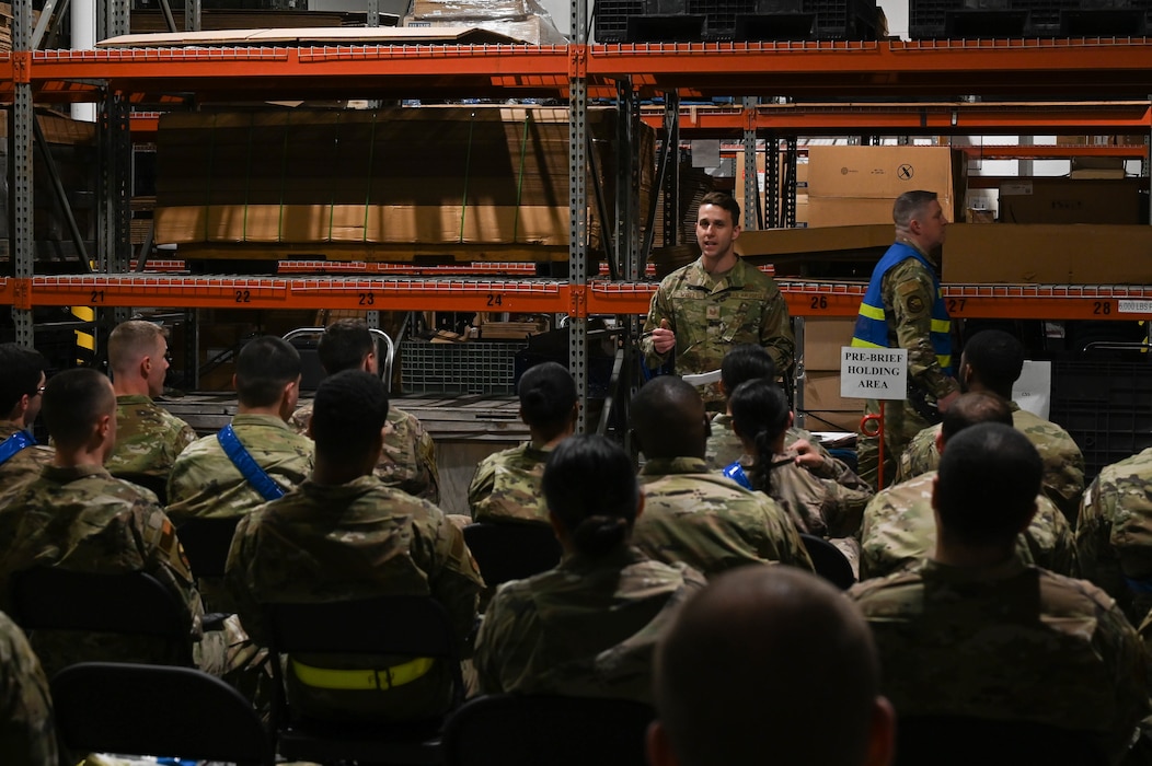 Tech Sgt. Patrick Wyatt, 375th Air Mobility Wing public affairs craftsman, briefs Airmen during a rapid deployment rehearsal on Scott Air Force Base, Illinois, March 16, 2022.  This deployment mobility rehearsal emphasizes readiness of command and control procedures and continuity of operations in a simulated contested environment. (U.S. Air Force photo by Airman 1st Class Mark Sulaica)