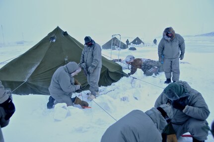 Soldiers from the 86th Infantry Brigade Combat Team (Mountain), Vermont Army National Guard, set up their bivouac site in the Arctic Circle, March 3, 2014 during Guerrier Nordique extreme cold weather training in Canada.
