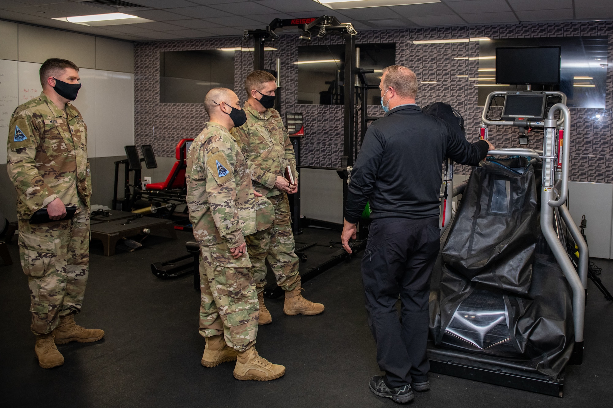 Joe Kirkman (center), Special Warfare Training Wing, physical therapist, briefs the SWTW training process and equipment during the STARCOM Senior Leadership Visit, Feb. 16, 2022, Joint Base San Antonio-Chapman Annex, Texas. The STARCOM senior leaders learned how the SWTW combines research, technology integration, strength and conditioning, performance nutrition, physical and occupational therapy, and psychology into the Air Force Special Warfare training pipeline. (U.S. Air Force photo by Thomas Coney).