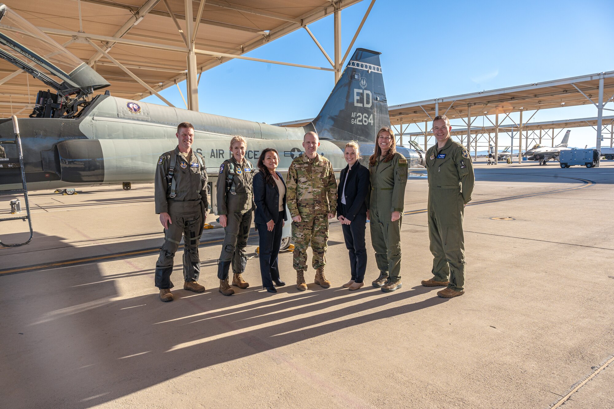 Group photo of Lt. Col. Joshua Egan, 412th Test Wing Chief of Safety, Maj. Gen. Jeannie Leavitt, Department of the Air Force Chief of Safety, MyNga Day, 412th Test Wing Protocol Chief, Brig. Gen. Matthew Higer, 412th Test Wing Commander, Alicia Helton, 412th Test Wing Protocol Specialist, Laura Macaluso, Director, Department of Defense Force Safety and Occupational Health, and Maj. Philip Downing, 370th Flight Test Squadron, F-16 Test Pilot