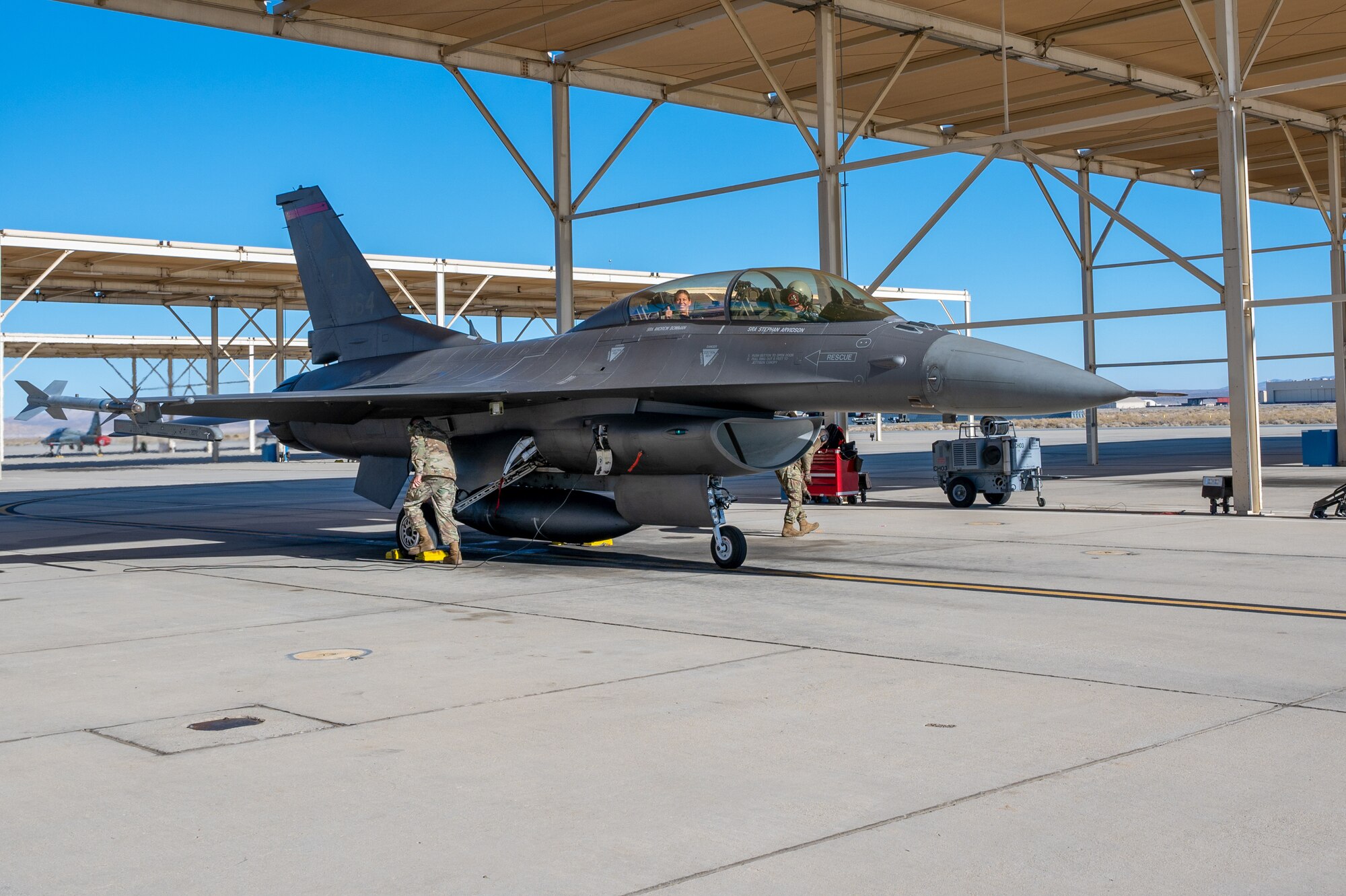 Laura Macaluso, Director, Department of Defense Force Safety and Occupational Health, gives the thumbs up following her orientation flight with Maj. Philip Downing, 370th Flight Test Squadron, F-16 Test Pilot