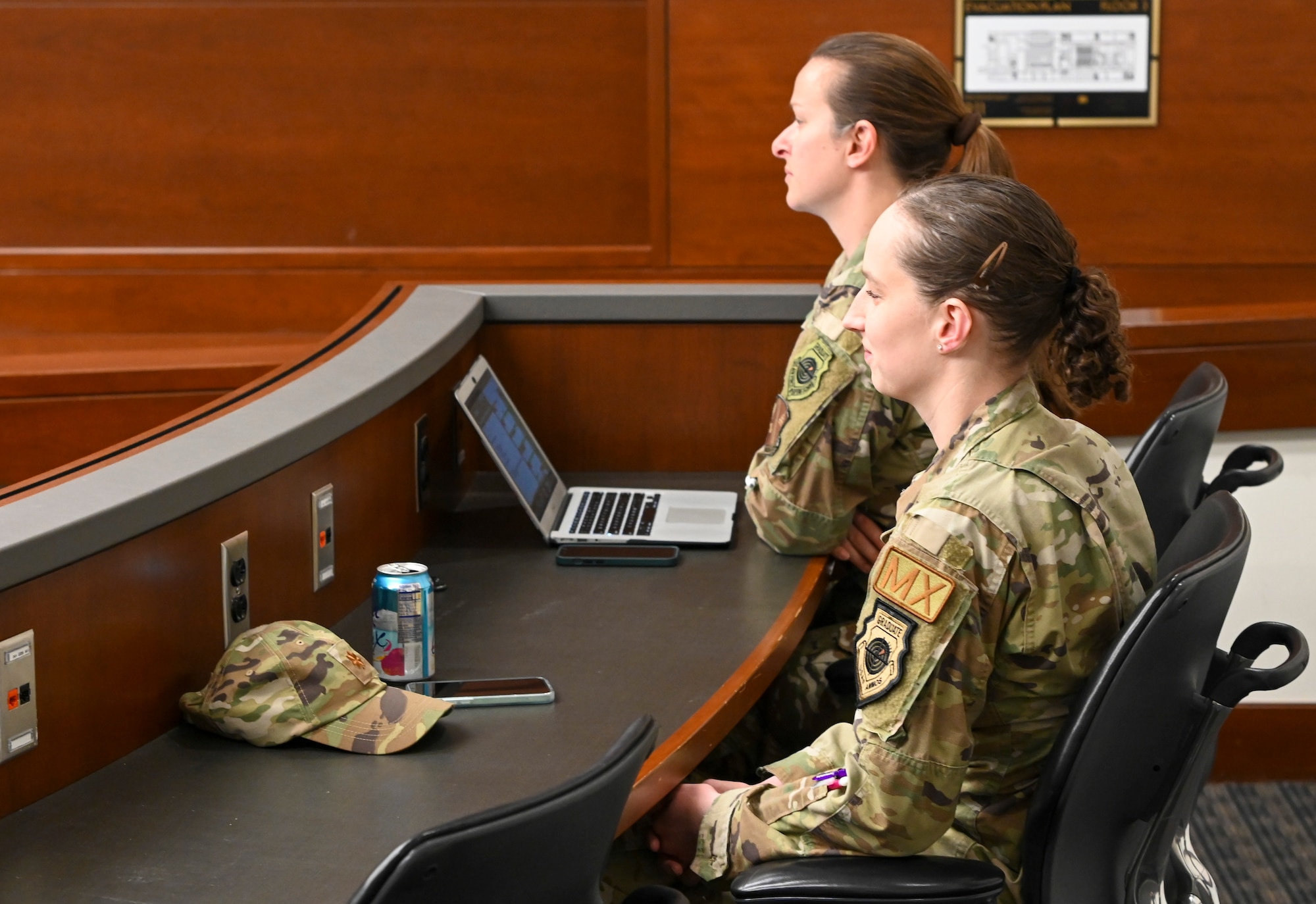 Female Air Force members sit in classroom.