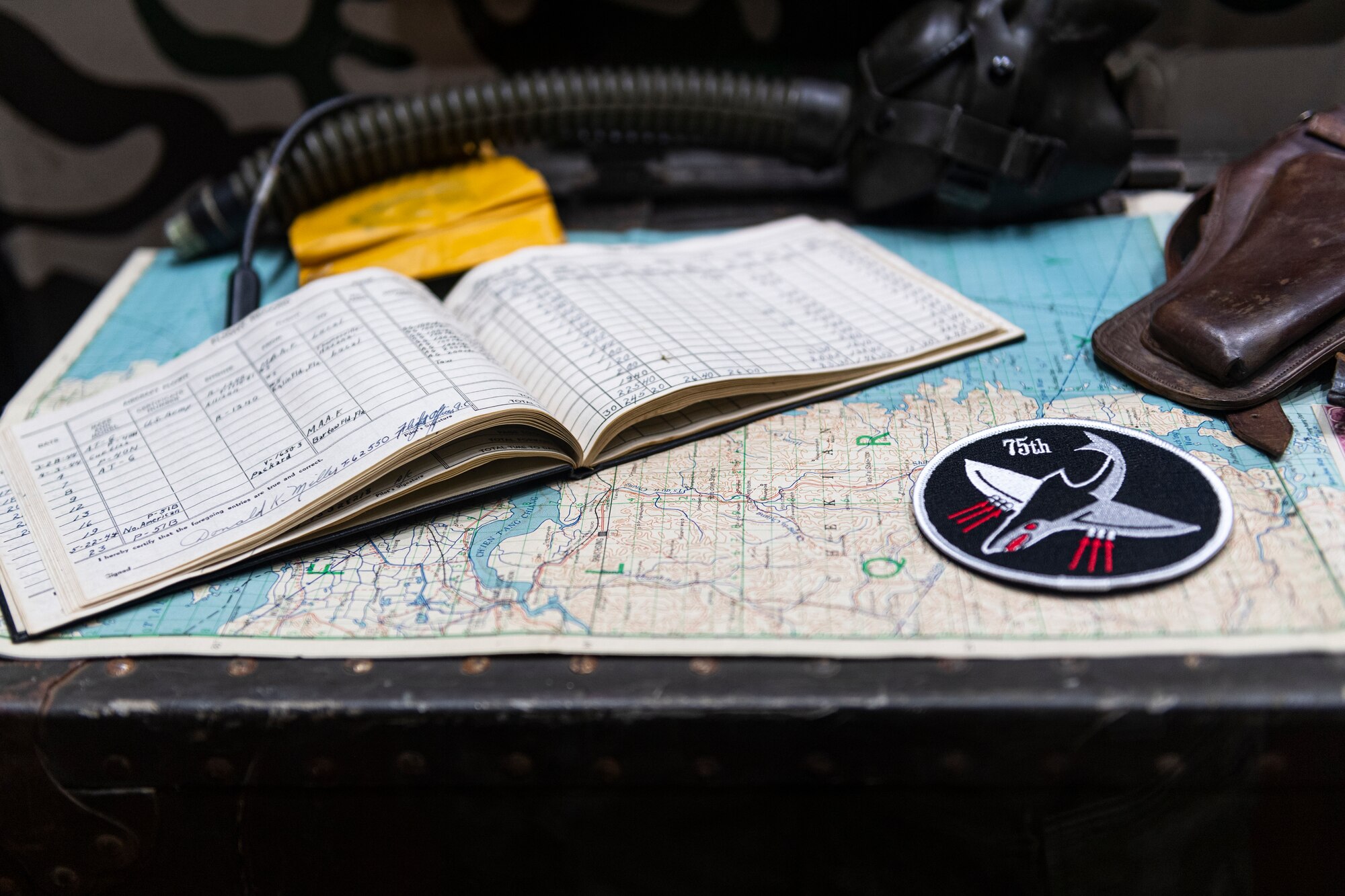 picture of a flight log and squadron patch