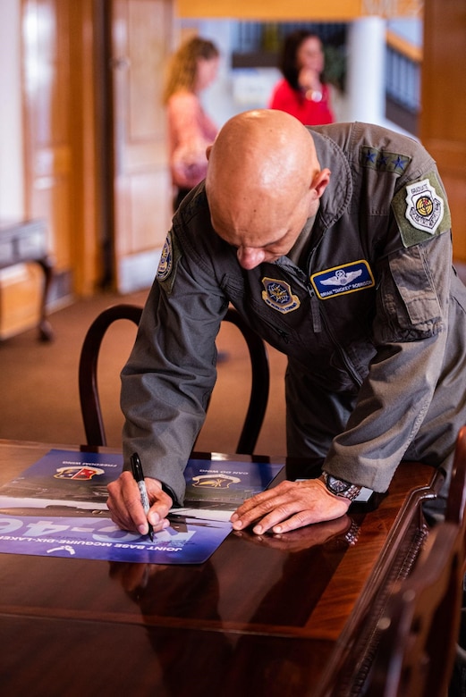 Lt. Gen. Brian Robinson signs poster