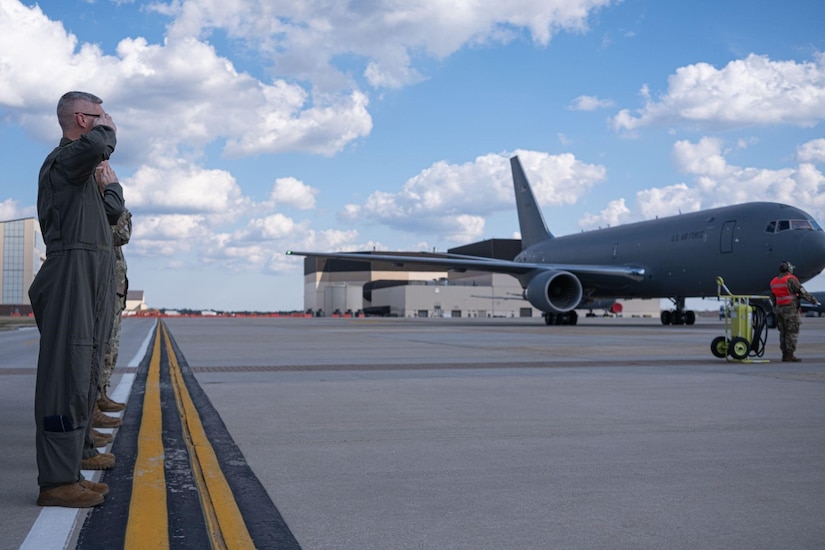 Service members salute a KC-46a