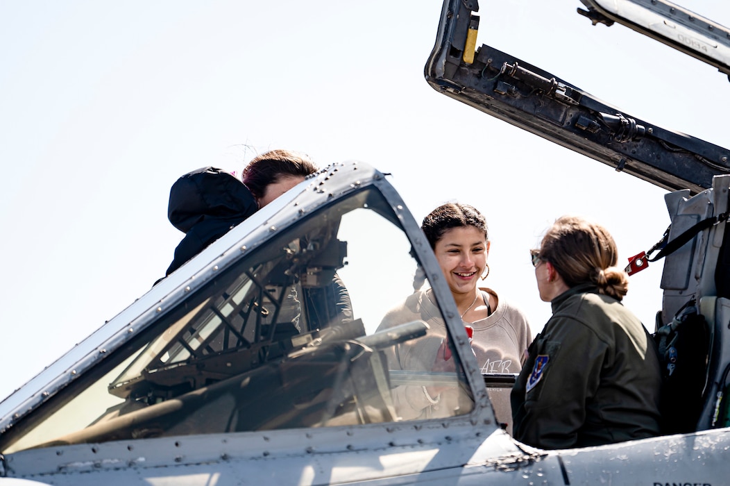 Photo of family talking to a pilot who is in an aircraft