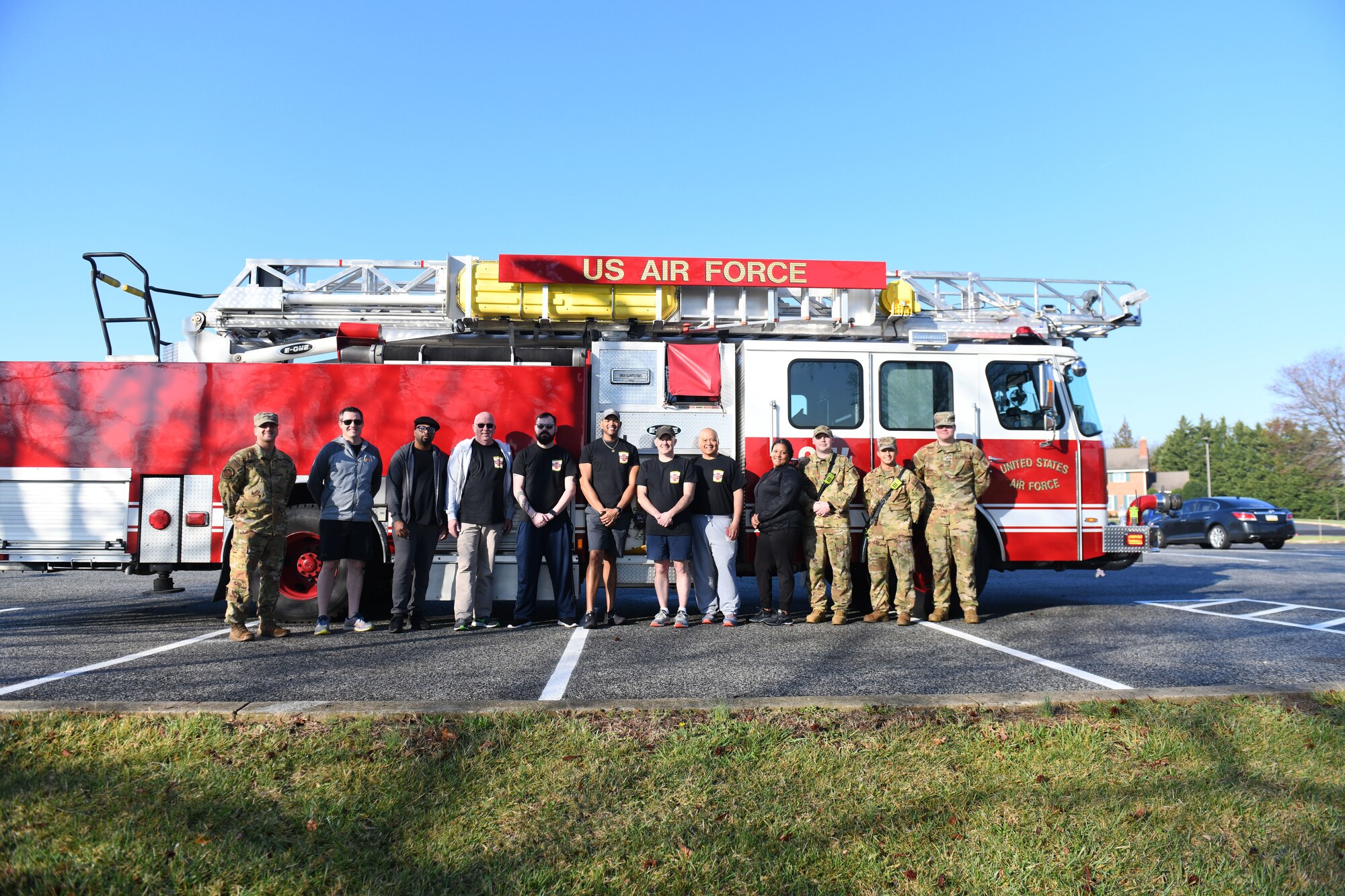 Joint Base Andrews community members pose for a photo after participating in a self-paced 5K in honor of responders on JBA, Md., March 18, 2022. The JBA Chapel hosted the 5K to honor fallen firefighters and an Anne Arundel County firefighter battling amyotrophic lateral sclerosis, or ALS. (U.S. Air Force photo by Senior Airman Essence Myricks)