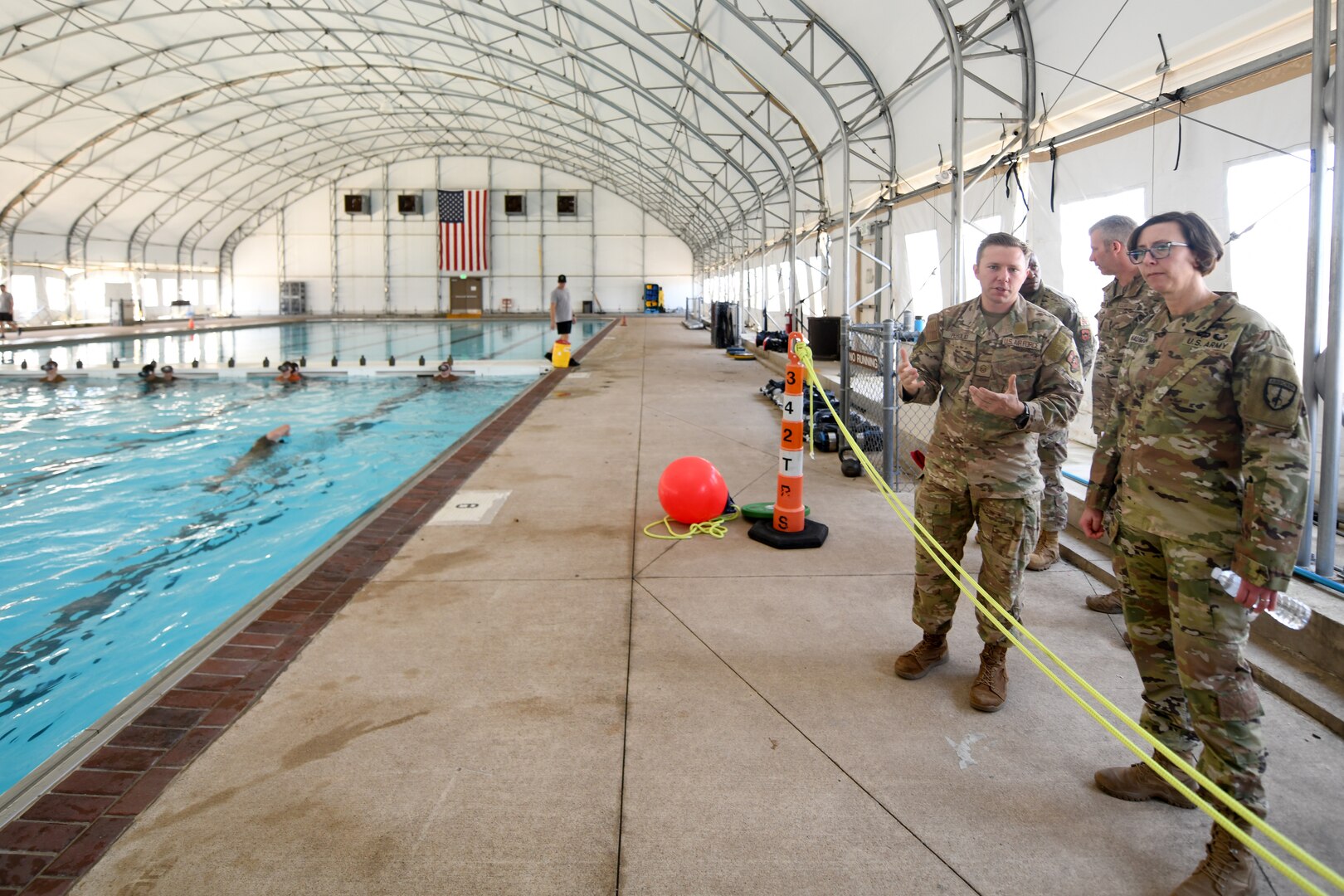 U.S. Army Command Sgt. Maj. JoAnn Naumann, command senior enlisted leader, U.S. Special Operations Command, Korea (right) speaks with U.S. Air Force Master Sgt. Michael Perolio, Special Warfare Training Flight Superintendent, (left) about the Assessment and Selection process for Air Force Special Warefare candidates at Joint Base San Anotnio, TX, Mar. 16, 2022. Naumann visited the area to mentor the NCOs and observe the SWTW Assessment and Selection process. (U.S. Air Force photo by Brian Boisvert)