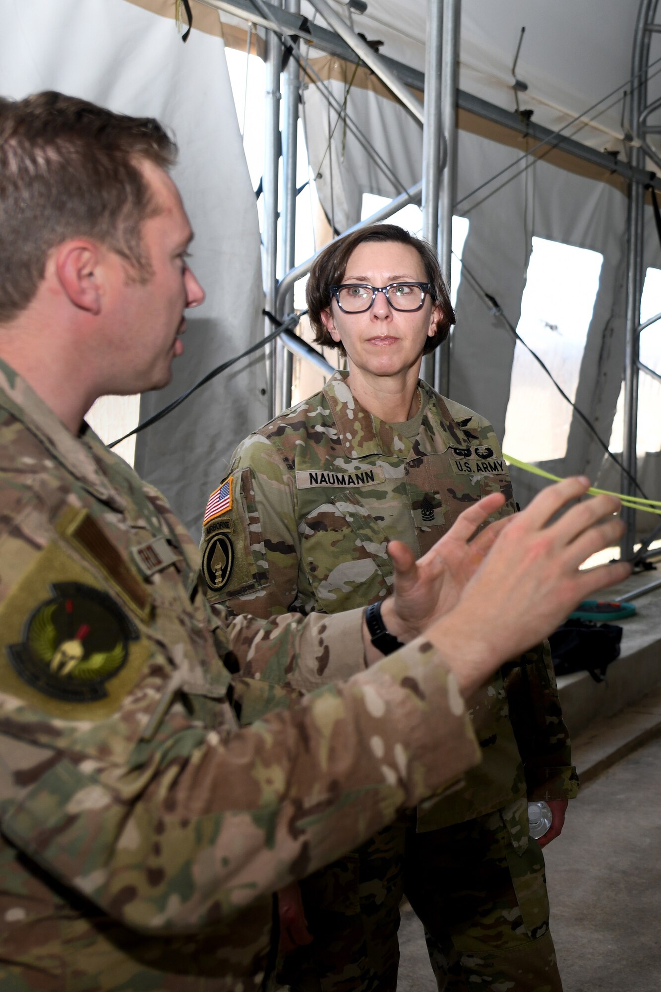 U.S. Army Command Sgt. Maj. JoAnn Naumann, command senior enlisted leader, U.S. Special Operations Command, Korea (right) speaks with U.S. Air Force Master Sgt. Michael Perolio, Special Warfare Training Flight Superintendent, (left) about the Assessment and Selection process for Air Force Special Warefare candidates at Joint Base San Anotnio, TX, Mar. 16, 2022. Naumann visited the area to mentor the NCOs and observe the SWTW Assessment and Selection process. (U.S. Air Force photo by Brian Boisvert)
