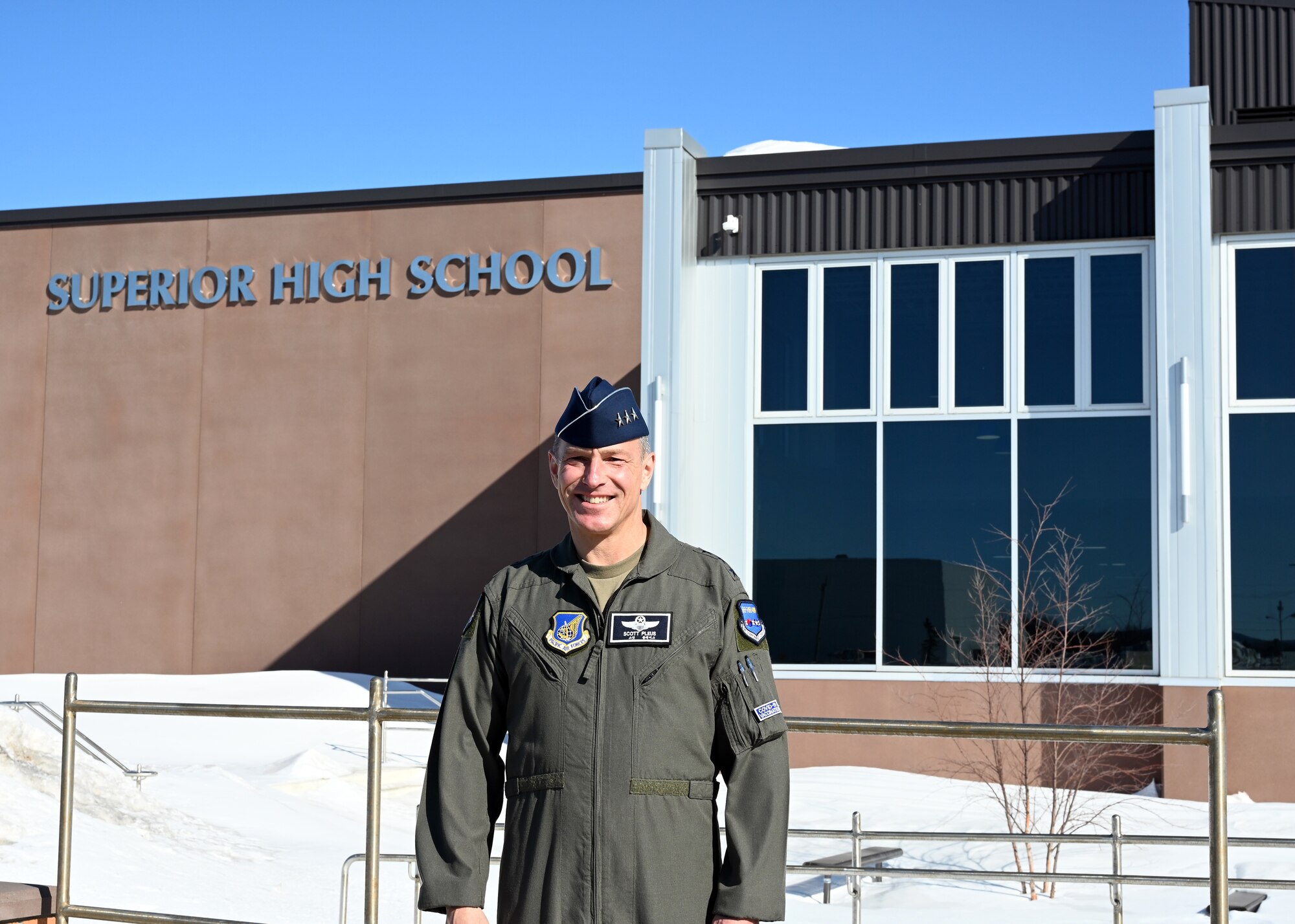 Lt. Gen. Scott Pleus poses for a photo in front of the school where he graduated years ago. He visited March 7, 2022 to inspire students to serve.