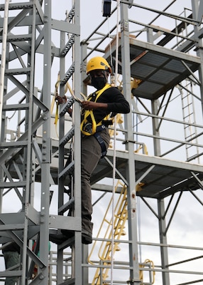 A newly hired Civil Service Mariner (CIVMAR) uses a 'Y' lanyard to transit aloft at the Military Sealift Command Training Center East on Joint Base Langley-Fort Eustis, Virginia, Feb. 22.