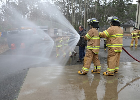 Newly hired Civil Service Mariners (CIVMAR) demonstrate their ability to operate firefighting hoses, at the Military Sealift Command Training Center East on Joint Base Langley-Fort Eustis, Virginia, Feb. 23.