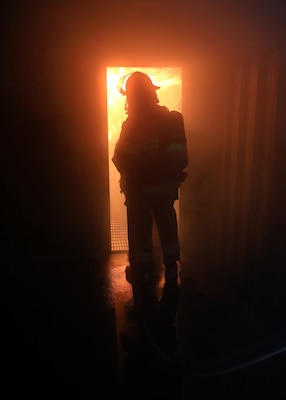 Newly hired Civil Service Mariners (CIVMAR) use a fire hose to extinguish a simulated ship's engine room fire at the Military Sealift Command Training Center East on Joint Base Langley-Fort Eustis, Virginia, Feb. 23.