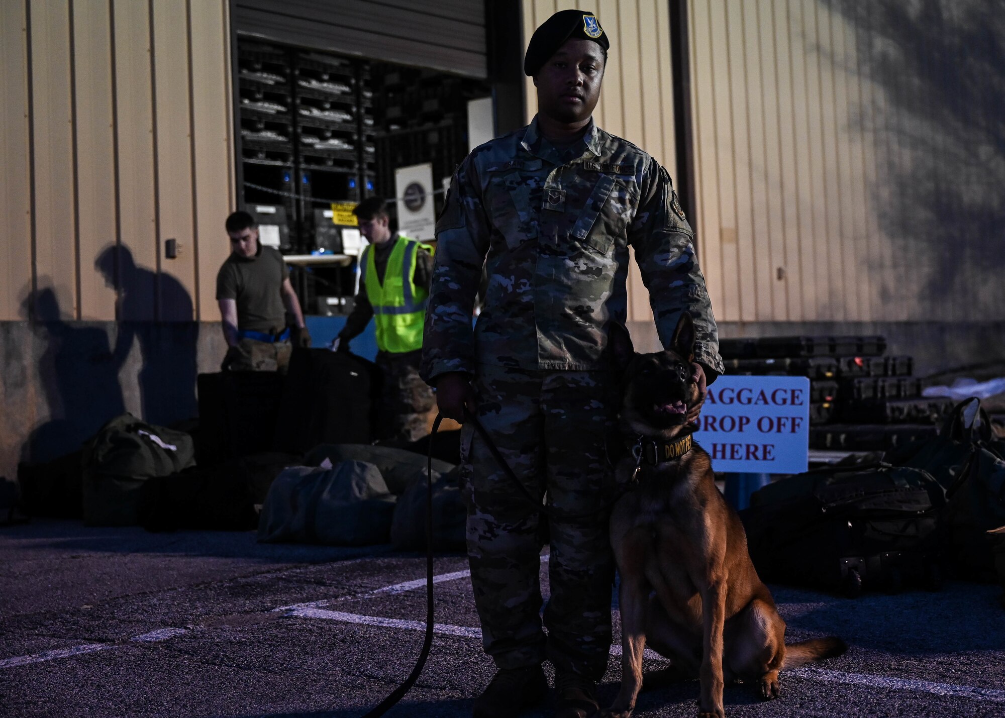 Staff Sgt. Kye Grant, 375th Security Forces Squadron military working dog handler, inspects luggage during a rapid deployment rehearsal on Scott Air Force Base, Illinois, March 16, 2022. This deployment mobility rehearsal emphasizes readiness of command and control procedures and continuity of operations in a simulated contested environment. (U.S. Air Force photo by Airman 1st Class Mark Sulaica)