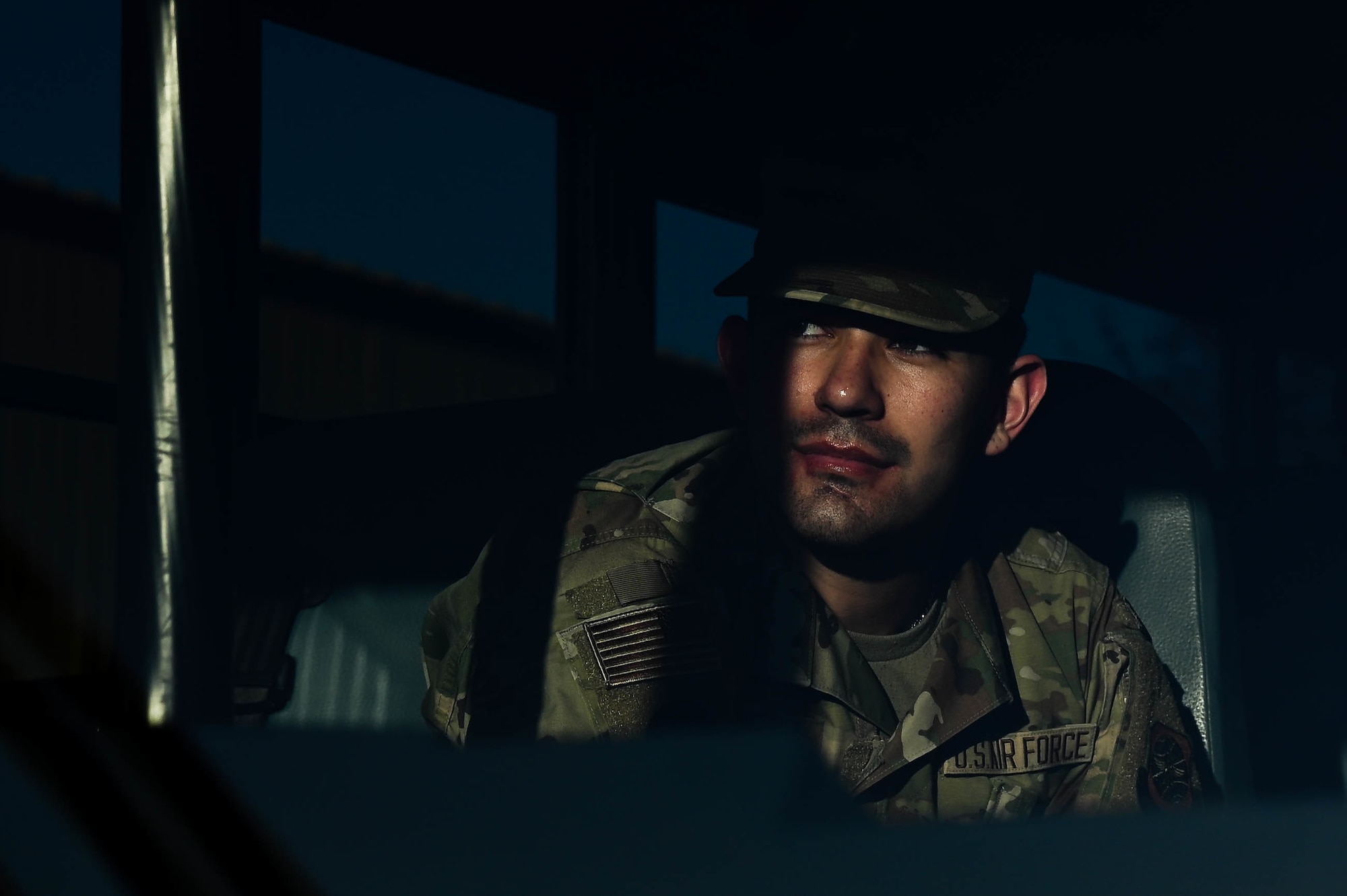 Amn Nicolas Vazquez, 375th Force Support Squadron food service apprentice, sits on a bus waiting to pick up equipment during a rapid deployment rehearsal on Scott Air Force Base, Illinois March 16, 2022. This rehearsal emphasizes readiness of command and control procedures and continuity of operations in a simulated contested environment.(U.S. Photo by Airman 1st Class Mark Sulaica)