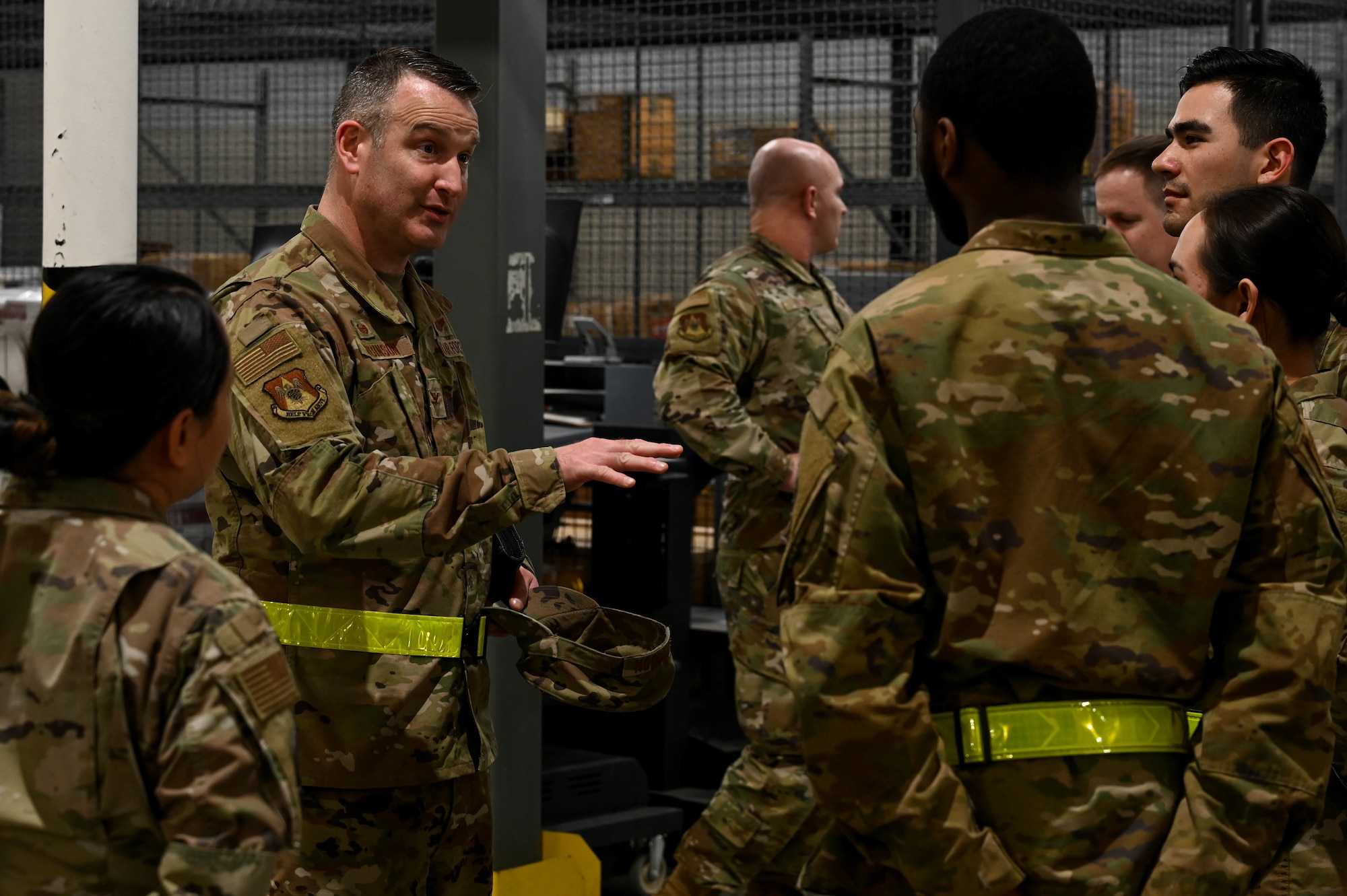 Col. Chris Robinson, 375th Air Mobility Wing commander, interacts with Airmen during a rapid deployment rehearsal on Scott Air Force Base, Illinois, March 16, 2022. This deployment mobility rehearsal emphasizes readiness of command and control procedures and continuity of operations in a simulated contested environment. (U.S. Air Force photo by Airman 1st Class Mark Sulaica)