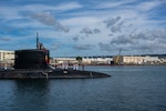 Sailors assigned to the Virginia-class fast-attack submarine USS Minnesota (SSN 783) heave mooring lines as the boat makes its homecoming arrival at Joint Base Pearl Harbor-Hickam.