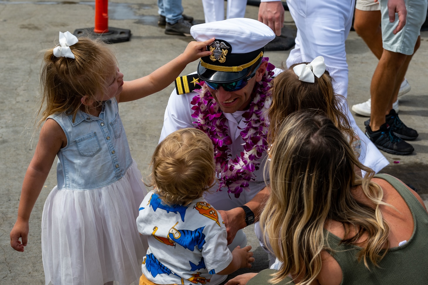 Lt. Macklen Lethin reunites with his children on the submarine piers at Joint Base Pearl Harbor-Hickam after Minnesota completed a change of homeport from Groton, Conn., March 17.