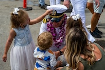 Lt. Macklen Lethin reunites with his children on the submarine piers at Joint Base Pearl Harbor-Hickam after Minnesota completed a change of homeport from Groton, Conn., March 17.