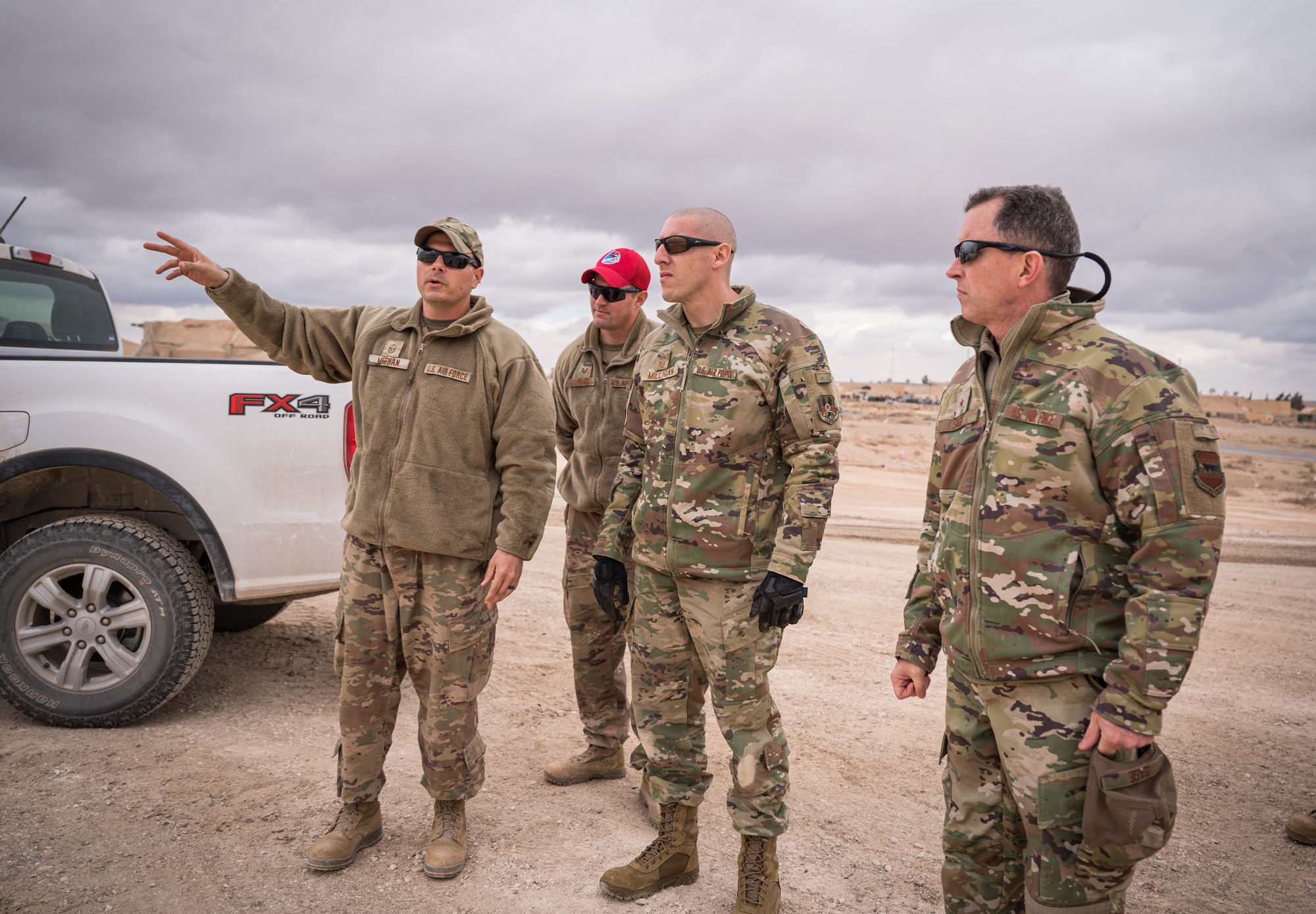 U.S. Air Force Master Sgt. Joseph Meehan, 577th Expeditionary Prime Beef Squadron and Tech. Sgt. James Gasbarro, 557th Expeditionary Red Horse Squadron, overrun project managers, give Brig. Gen. Christopher Sage, 332d Air Expeditionary Wing commander, and Chief Master Sgt. Sean Milligan, 332d AEW command chief, an overview of working being done to expand the current runway at an undisclosed location in Southwest Asia March 12, 2022. (U.S. Air Force photo by Master Sgt. Christopher Parr)