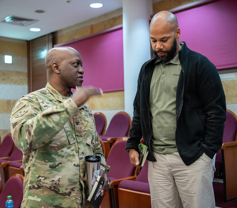 Col. Kenneth Reed, commander of the U.S. Army Corps of Engineers Transatlantic Division's Expeditionary District, discusses construction projects with Kendrick Lawrence, a program manager, before the start of the 7th Biannual Project Financial Management Review, held at the Kuwait Ministry of Defense, Kuwait City, on Mar. 16, 2022.