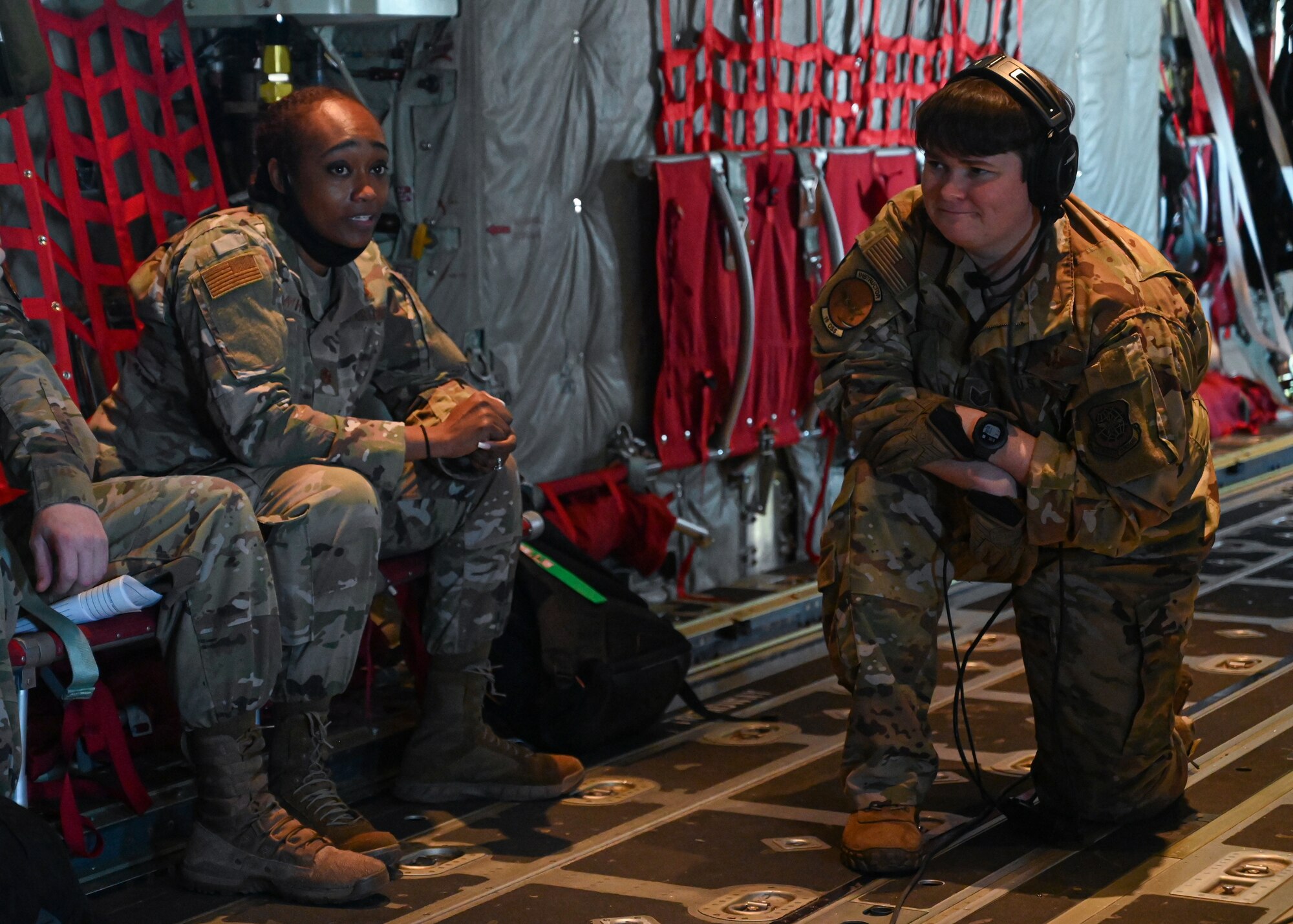 Tech. Sgt. Elizabeth Patton, 41st Airlift Squadron C-130J Super Hercules loadmaster, speaks with Maj. Nicole White, Tuskegee University AFROTC Detachment 15 assistant professor of aerospace studies, during an orientation flight